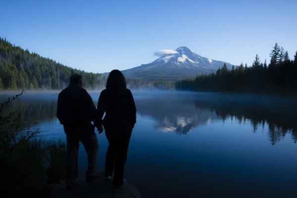 Couple holding hands at Trillium Lake at dusk
